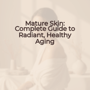 A woman with radiant, healthy skin smiling gently as she touches her face, against a soft, blurred background in warm beige and cream tones.