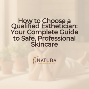 A woman with a towel wrap in a spa setting, her glowing skin visible as she touches her face with a relaxed, confident smile. The background is softly blurred with warm, natural lighting and beige, cream, and soft brown tones, conveying a luxurious and trustworthy spa-like mood.