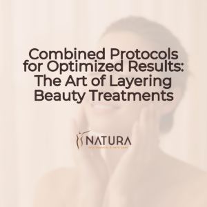 A tasteful female model (woman, eyes closed, soft bokeh) with natural glowing skin, relaxed pose touching face, and genuine confident smile, with soft diffused lighting, against a slightly blurred background in warm beige, cream, and soft brown tones.