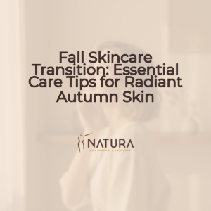 A woman with short, minimalist hair and natural glowing skin smiles confidently while gently touching her face, in a soft, warm, and natural setting.