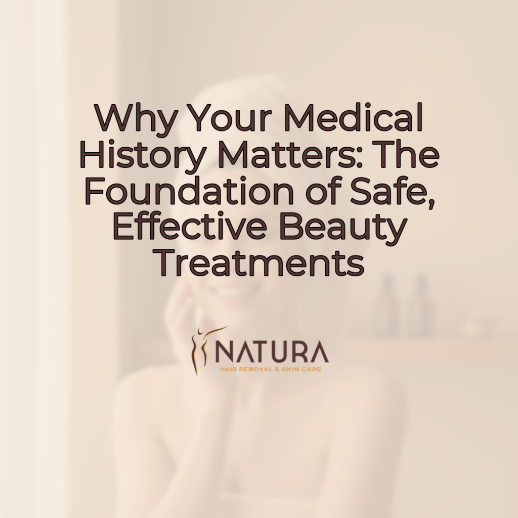 A woman in a towel wrap, in a spa setting, with glowing skin, smiling and touching her face. The background is softly blurred.