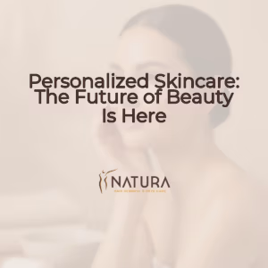 A woman with naturally glowing skin, a dewy complexion, and a soft genuine smile gently touches her face.