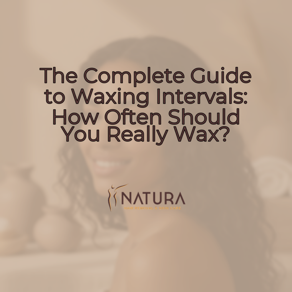 A woman with naturally glowing skin posing with a confident smile, in a spa-like setting.