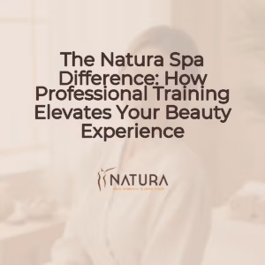 A woman with radiant skin, softly lit, in a natural spa setting. She has a serene expression and a gentle smile, with her hand lightly touching her face. The background is blurred, focusing on her tranquil presence, evoking a luxurious and natural skincare experience. The overall tone is warm and inviting, using a palette of soft beiges, creams, and browns. This image is professional and designed to promote a sense of wellness and natural beauty.