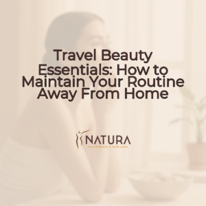 A woman with glowing skin touching her face, captured in warm, natural light.