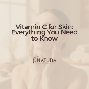 A woman with radiant skin in a relaxed spa pose, her hand gently touching her face, and a genuine smile. Soft, diffused lighting highlights her natural glow against a subtly blurred warm beige and cream background, embodying a luxurious and natural skincare mood.