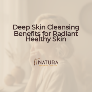 A woman with short hair and glowing skin, in a relaxed pose, with a genuine smile. Soft lighting, blurred background.