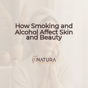 A woman with glowing skin in a relaxed spa pose, touching her face with a genuine confident smile. The image has a soft, warm, natural aesthetic with blurred background.