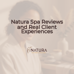 A woman with naturally glowing skin smiles serenely as she touches her face, against a softly blurred background. Her pose is relaxed and confident, reflecting a spa-like tranquility.