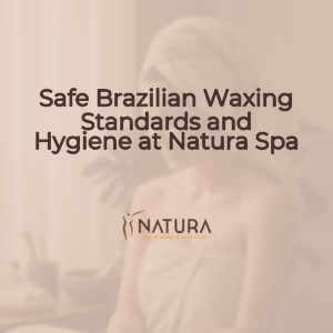 A woman with naturally glowing skin, relaxed pose touching her face, and a genuine confident smile, in a soft, diffused lighting spa setting.