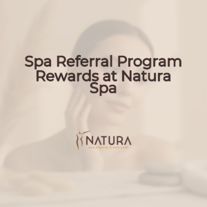 A serene female model with glowing skin in a spa setting, looking contemplative yet confident. The background is softly blurred with warm, natural tones.