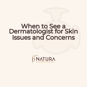 A woman with glowing skin, soft smile, and relaxed pose touching her face. The image is professional, with warm, diffused lighting and a slightly blurred background.