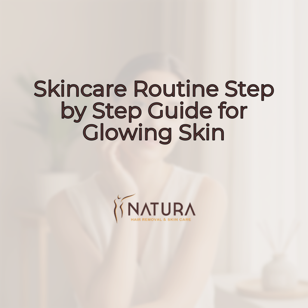 A woman with dewy complexion and a soft, confident smile, gently touching her face. The background is softly blurred with warm beiges and creams. She embodies a natural, luxurious skincare aesthetic.